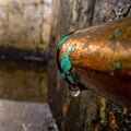 Leaking Copper Pipe with Corrosion and Water Drop Royalty Free Stock Photo