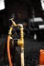 Leaking Fire Hydrant Spraying Water Closeup UK city hose yellow freeze time dark background  worker tap focus bokeh sharp Royalty Free Stock Photo