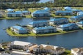 Leaking roofs of residential condos covered with protective tarp sheets against rain water leaks until replacement of Royalty Free Stock Photo