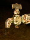 Leaking water of old rusty tap. Royalty Free Stock Photo