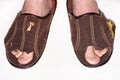 Leaky brown slippers. Royalty Free Stock Photo