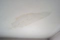 Leaky roof dampness in bedroom ceiling walls. Water droplets forming and dripping from damp ceiling from rain water flooding. Royalty Free Stock Photo