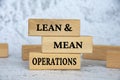 Lean and mean operations text on wooden blocks. Business strategy concept Royalty Free Stock Photo