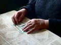 Lean purse. Old woman's hands and dollar bills on table, contrast shot, selective focus, very shallow DOF Royalty Free Stock Photo