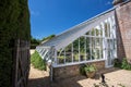 Lean-to greenhouse. Beautiful English country walled garden brick-built glasshouse Royalty Free Stock Photo