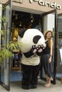 Leaning against giant panda doll