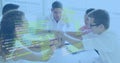 Leaning five team stacking hands atop white meeting table in sunny office, with tablet code overlay Royalty Free Stock Photo