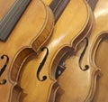 A Leaning Stack of Vintage Antique Violins