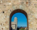 The leaning tower of pisa viewed through entrace arch of Piazza dei Miracoli