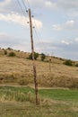 Leaning wooden electrical poles with wires Royalty Free Stock Photo