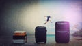 A leap back to summer. Confident young man traveler jumping over his luggage to get back to holiday. Tourist guy needs a vacation Royalty Free Stock Photo