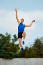 leap of determination frozen in this captivating long jump photo. motivated young man, professional sportsman doing