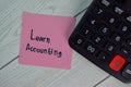 Learn Accounting write on sticky notes isolated on Wooden Table Royalty Free Stock Photo