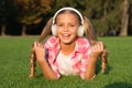 Learn any language in fun way. Happy kid wear headphones lying on green grass. Foreign language courses. English school