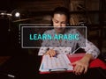 LEARN ARABIC text in block of quotes. Bookkeeping clerk doing paperwork