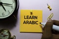 Learn Arabic text on sticky notes on office desk