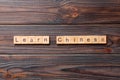 Learn chinese word written on wood block. Learn chinese text on table, concept Royalty Free Stock Photo