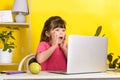 Learn English concept with kids, girl using her laptop. Kid using laptop watching online e-learning video