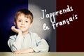 Learn french language concept. Happy child student Royalty Free Stock Photo