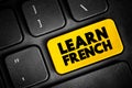 Learn French text button on keyboard, concept background Royalty Free Stock Photo