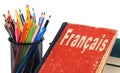 Learn French, textbook and pencils isolated