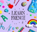 Learn French theme with school supplies on a purple background