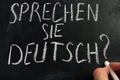 Learn German. Sprechen Sie Deutsch sign on a blackboard Royalty Free Stock Photo