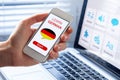 Learn German language online concept, mobile phone, flag of Germany Royalty Free Stock Photo