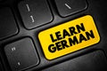 Learn German text button on keyboard, concept background Royalty Free Stock Photo