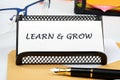 Learn and Grow written on a business card on the table Royalty Free Stock Photo