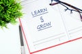 Learn and Grow written in a notebook on the table Royalty Free Stock Photo