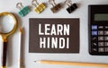 learn Hindi language sign on black background