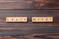 Learn Hindi word written on wood block. Learn Hindi text on table, concept