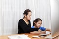 Learn from home concept. Mother and daughter learning to write, mother teaching little girl homework. Covid-19 outbreak student Royalty Free Stock Photo