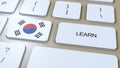 Learn Korean Language Concept. Online Study Courses. Button with Text on Keyboard. 3D Illustration