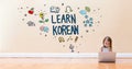 Learn Korean text with little girl using a laptop computer