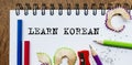 Learn Korean text written on a paper with pencils in office