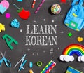 Learn Korean theme with school supplies on a chalkboard