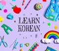 Learn Korean theme with school supplies on a purple background