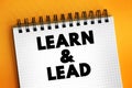 Learn and Lead - helps new managers make the transition from individual contributors to effective leaders, text concept on notepad Royalty Free Stock Photo