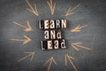 Learn and Lead. Letters of the alphabet with text on a dark chalk board Royalty Free Stock Photo