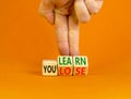 We learn or lose symbol. Concept words We learn and We lose on wooden cubes. Businessman hand. Beautiful orange table orange Royalty Free Stock Photo