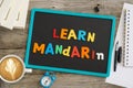 Learn Mandarin written on chalkboard with plastic letters, educational advice