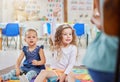 We learn so much at creche. a little girl raising her hand in class. Royalty Free Stock Photo