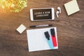 Learn a new language - an inscription on a smartphone, a notebook for writing foreign words, markers, wireless headphones