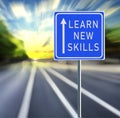 Learn New Skills Road Sign on a Speedy Background with Sunset. Royalty Free Stock Photo
