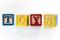 Learn by playing, vintage toys and educational play concept theme with close up of wood block toy spelling out the word toys Royalty Free Stock Photo