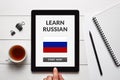 Learn Russian concept on tablet screen with office objects Royalty Free Stock Photo