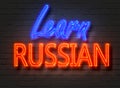 Learn Russian, neon sign on brick wall