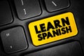 Learn Spanish text button on keyboard, concept background Royalty Free Stock Photo